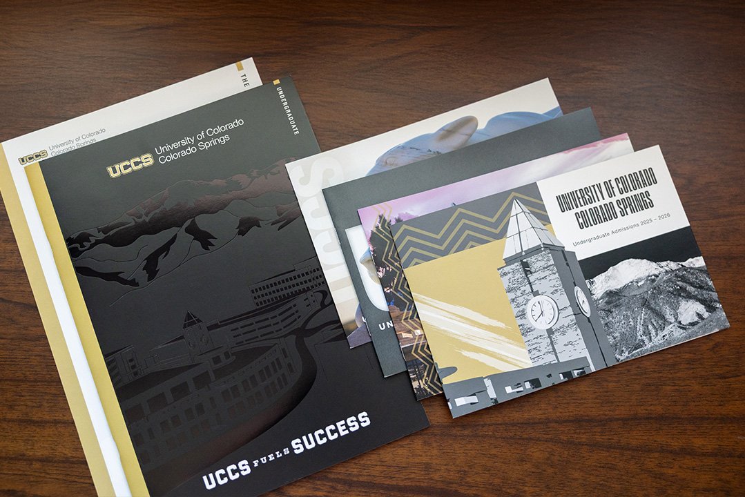 Stack of UCCS viewbooks from the past few years