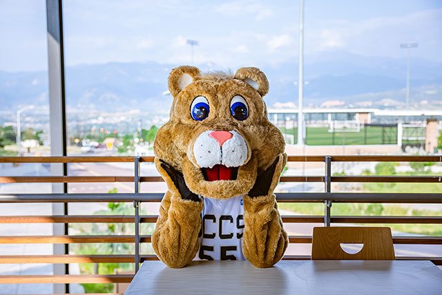 UCCS mascot Clyde sitting at table
