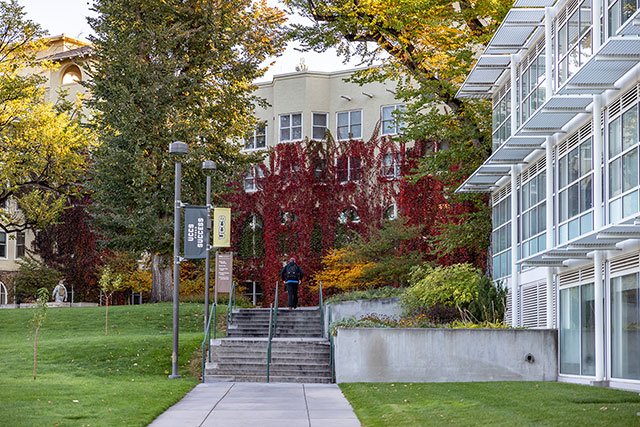 UCCS student walking by Main Hall in the fall