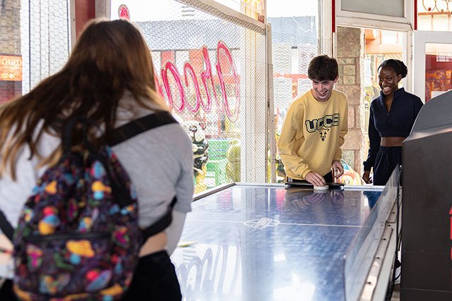UCCS students playing air hockey in Manitou Springs