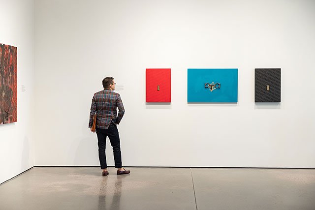 UCCS community member looking at artwork in GOCA gallery
