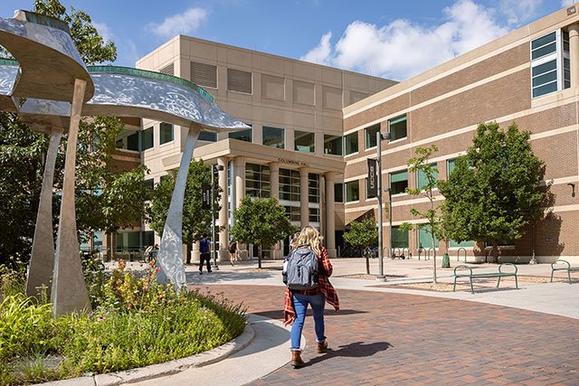UCCS student walking by Columbine Hall