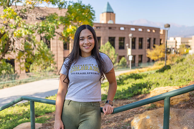 UCCS student in front of clock tower