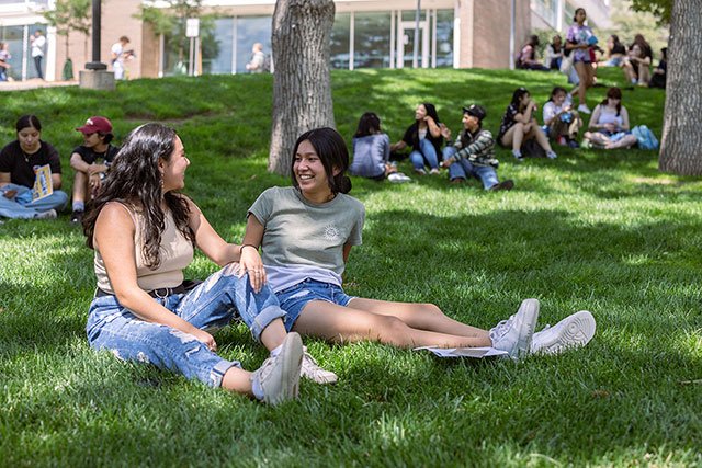 UCCS students sitting on lawn