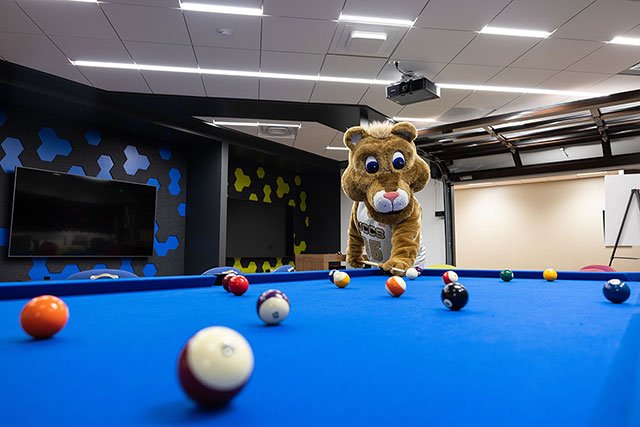 UCCS mascot Clyde playing pool