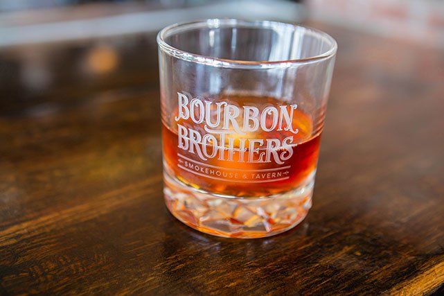 Bourbon Brothers branded glass with hard liquor