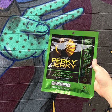 Perky Jerky with graffiti behind it
