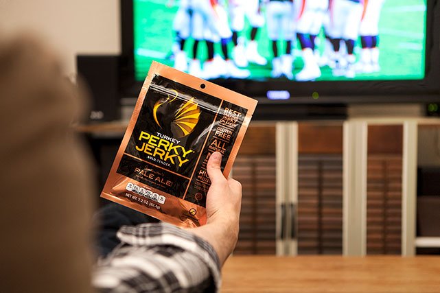 Perky Jerky being held in front of TV